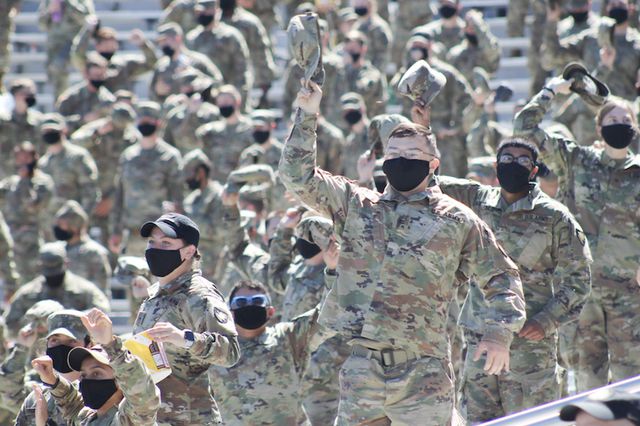 A photo of masked, cheering soldiers at the West Point season opener football game Sept. 5 at the military institute's football stadium.